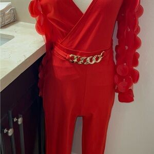 Chic Red Jumpsuit with Gold Chain Accent